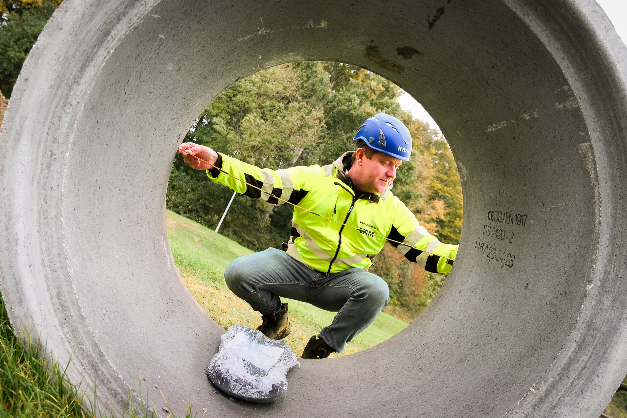 man with concrete pipe