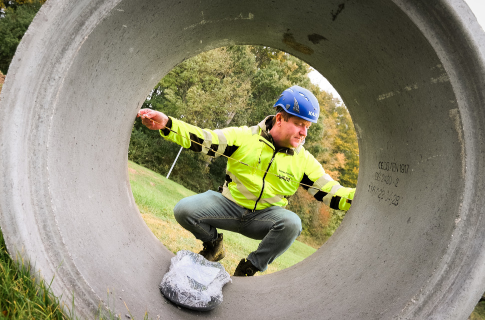 man with concrete pipe